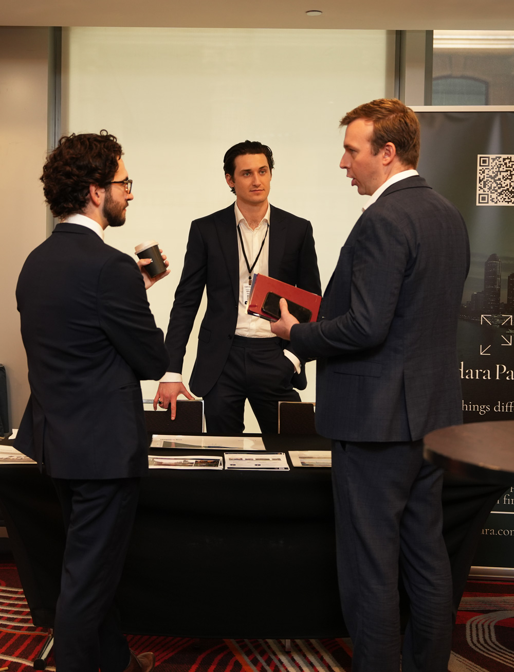 Family office conversation at a trade table
