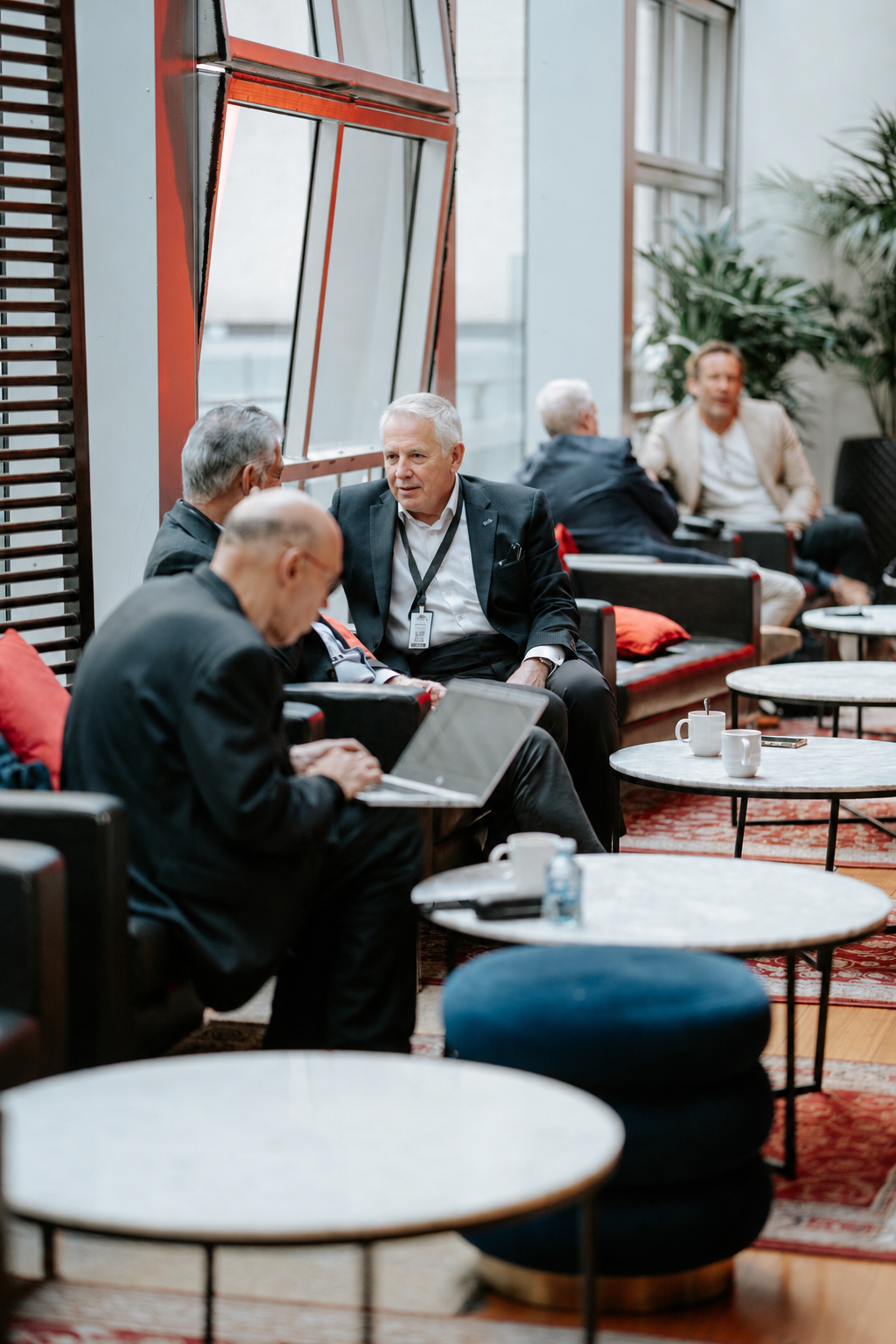 Investors in conversation in the VIP lounge